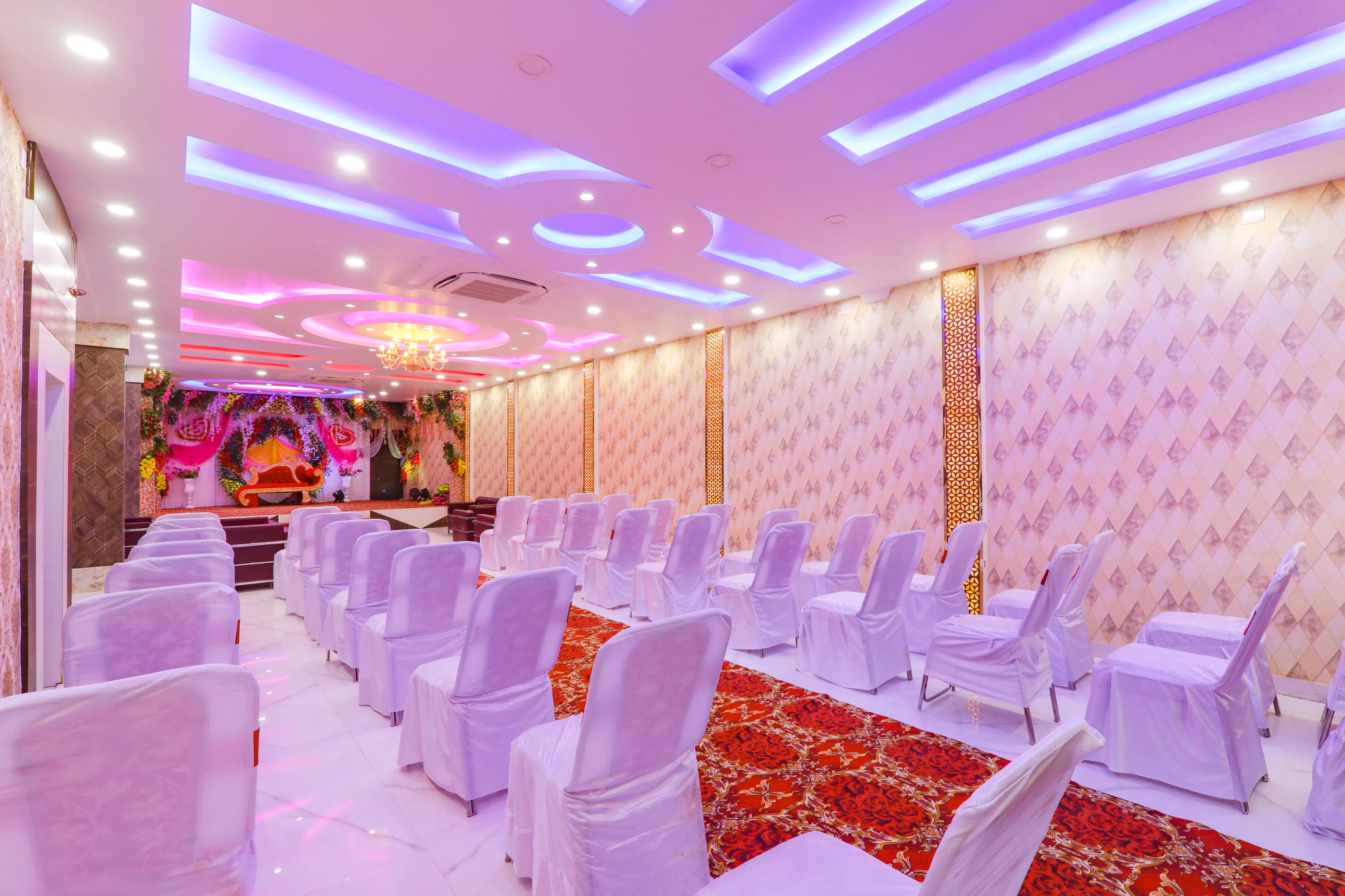 Banquet hall seating with floral stage at Hotel Nikunj